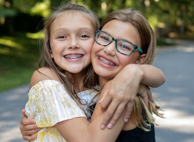 Two young girls wearing braces