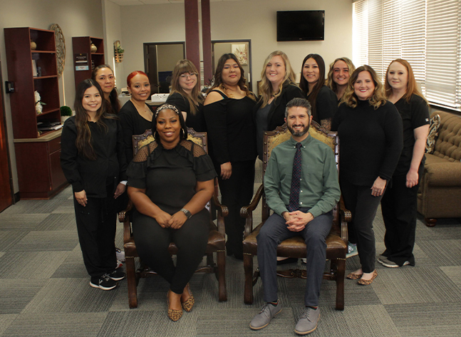 Doctor Ishani and team at Casady Square Orthodontics smiling in reception area