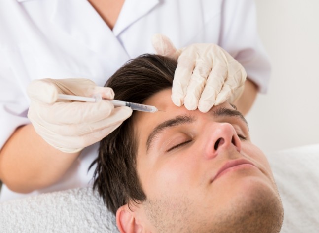 Man getting Botox injection in his forehead