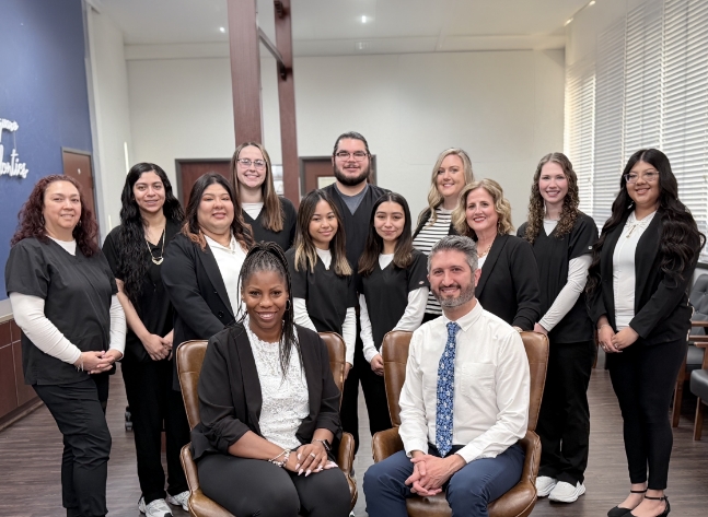Oklahoma City orthodontist and team smiling in reception area of Casady Square Orthodontics