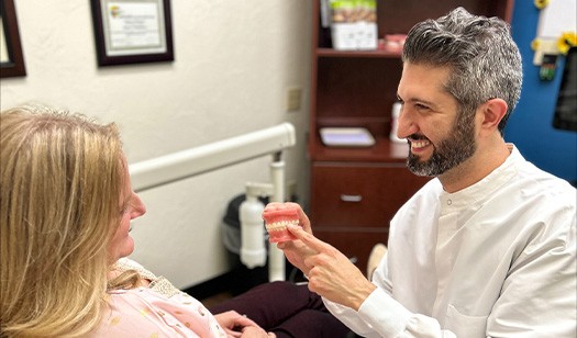 Doctor Ishani showing an orthodontic patient a model of the teeth