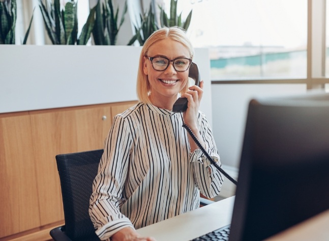 Smiling orthodontic team member talking on phone