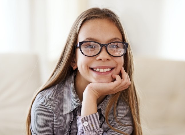 Smiling young girl with glasses