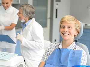 Teen smiling while sitting in treatment chair
