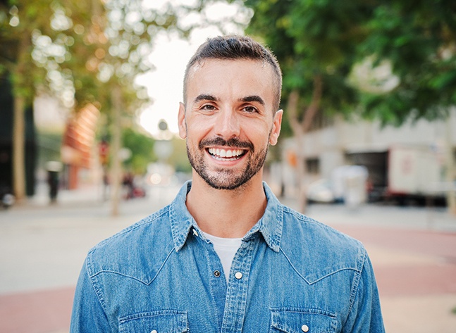 Portrait of happy, smiling man standing outdoors