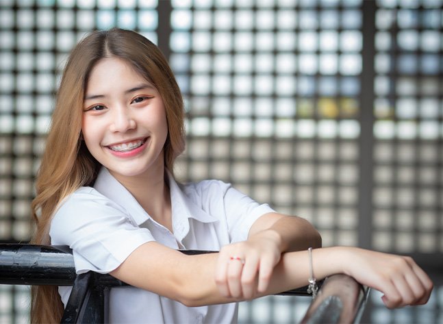 Teenage girl smiling after getting retainers and oral appliances in Oklahoma City