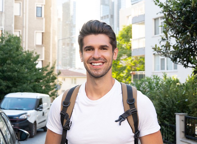 Man smiling outdoors with excellent oral health in Oklahoma City