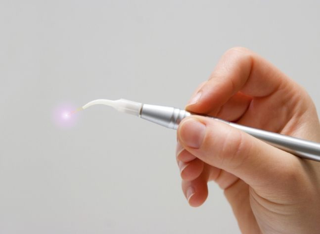 Hand holding a soft tissue laser