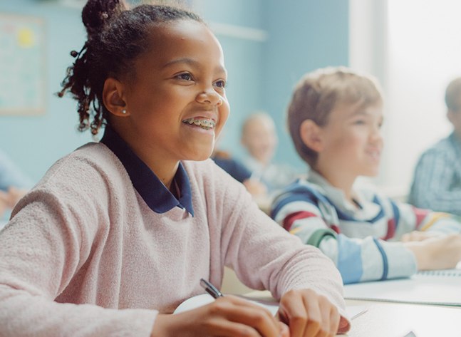 a child with braces paying attention in class
