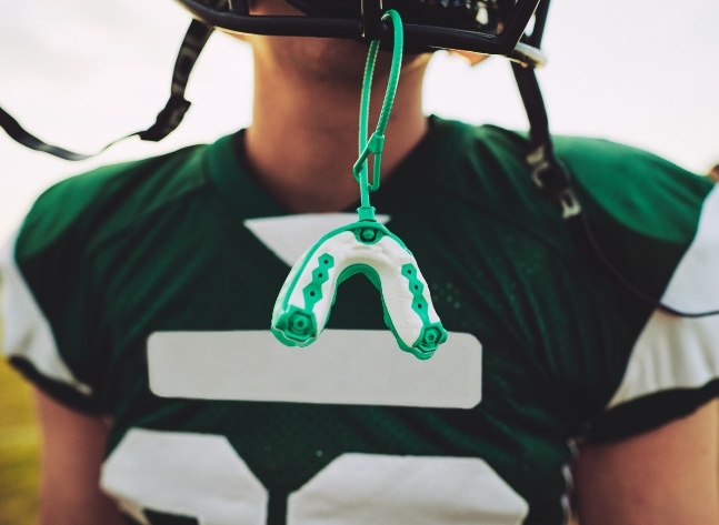 Athletic mouthguard hanging from football helmet