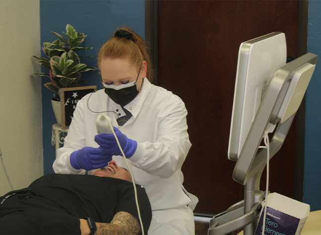 Orthdoontic team member scanning a patient's teeth in Oklahoma City orthodontic office