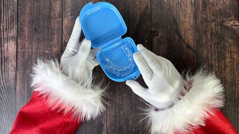 Santa hands and Invisalign in a protective case