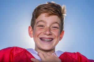 Teen athlete smiling with braces