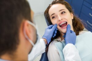 Dentist examining patient with braces.